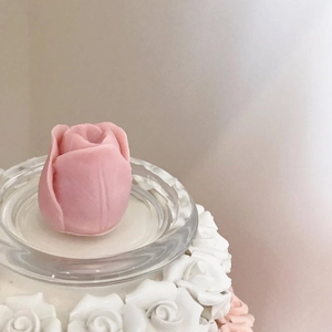 Pink tulip flower silicone candle mold on decorative floral base and glass tray