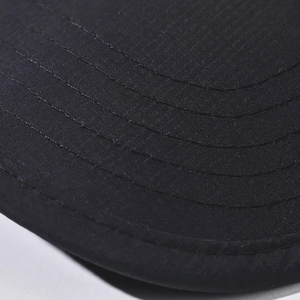 Macro detail of high-quality cotton baseball cap brim with precise parallel stitching
