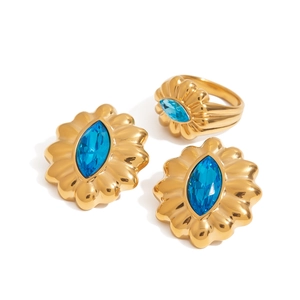Vintage gold jewelry set with blue marquise zircon stone earrings and ring on white