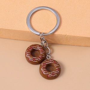Close-up of realistic brown donut keychains with colorful sprinkles and silver ring