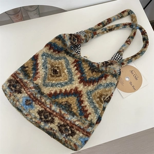 Detail view of plush tote bag with vintage geometric patterns and checkered inner lining