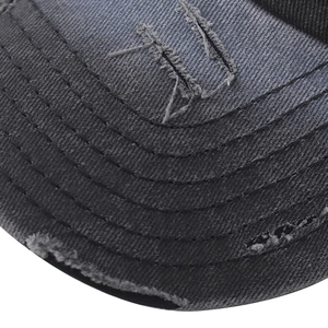 Close-up of distressed grey baseball cap with embroidery and vintage frayed brim details