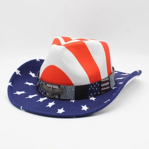 Detail of the American flag cowboy hat featuring a metal eagle badge and striped crown
