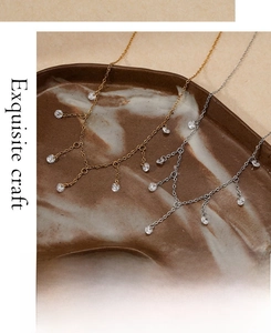Exquisite gold and silver tassel necklaces with round cubic zirconia in a ceramic tray