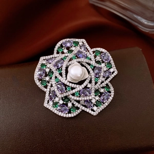 Macro detail of a vintage flower brooch with pearls, zircons, and colorful crystals