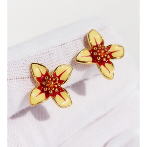 Elegant white enamel flower stud earrings with yellow petals and gold-plated edges