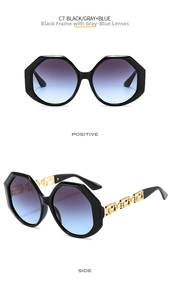 Detail of oversized polygon sunglasses featuring gold Greek key pattern on temple