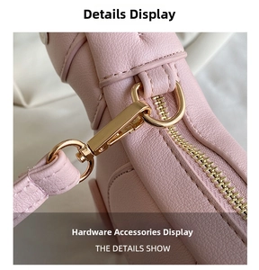 Detail of pink lychee leather texture with high-quality light gold metal zipper and D-ring