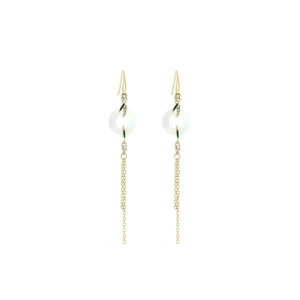 Detail of gold tassel earrings with white peace buckle and green bamboo leaf motif