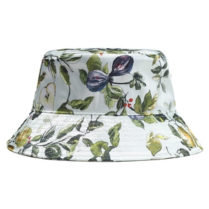 Detail of satin bucket hat with realistic fruit patterns and light blue silk finish