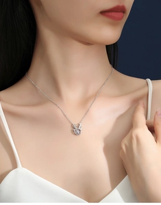 Primo piano del ciondolo a corno di cervo in argento S925 con moissanite su una modella