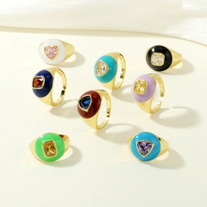 Macro detail of gold enamel rings featuring colorful heart and square-shaped zircons