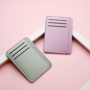 Detail view of ultra-thin PU leather card holders in pale green and purple with card slots