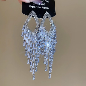 Detailed close-up of sparkling cubic zirconia tassel earrings with silver needle posts