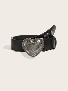 Detail of trendy heart-shaped metal buckle and black leather belt with punk style studs
