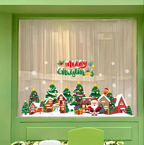 Detail of Christmas window stickers featuring Santa Claus, reindeer, and snowy village decals
