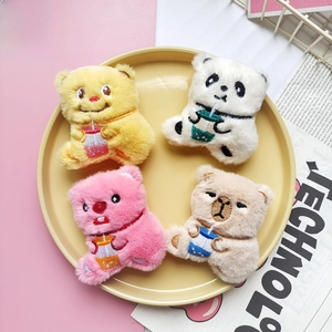 Detail of four cute plush bear accessories in yellow, white, pink and beige colors