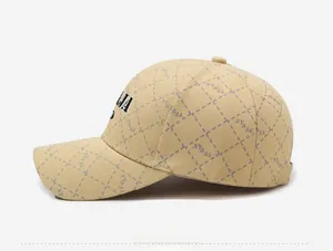 Detail of khaki baseball cap featuring lattice patterns and side NY&JA letter embroidery