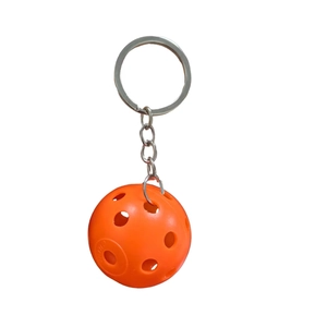 Detail of orange pickleball keychain with Franklin X-40 logo and metal ring attachment