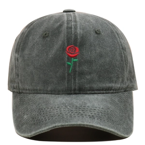 Detailed embroidery of a red rose on a vintage washed cotton baseball cap with curved brim