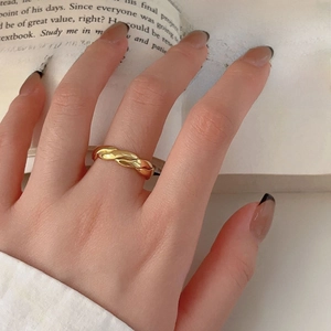 Minimalist 925 sterling silver ring with twisted rope design on a vintage book