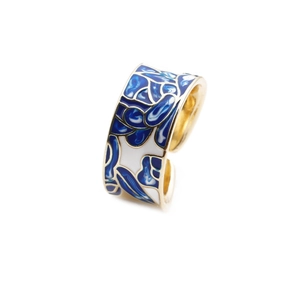 Detailed macro view of the colorful enamel patterns on the gold-plated open ring