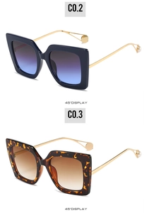 Detail view of square sunglasses with gold metal temples and elegant pearl tips
