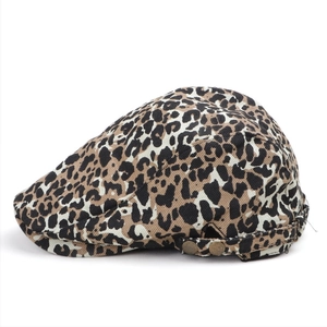 Detailed side view of vintage leopard print flat cap with dual metal side buckles
