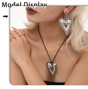Close-up of hammered silver heart earrings and matching pendant necklace on a model