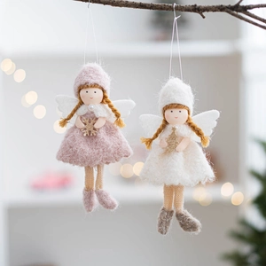Pair of felt Christmas angel ornaments in pink and white hanging on a tree