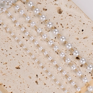 Vintage stainless steel pearl necklaces with four layers of varying sizes on stone