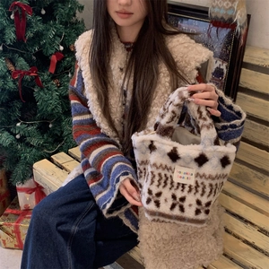 Detail of plush faux shearling handbag with Nordic geometric patterns and brand patch