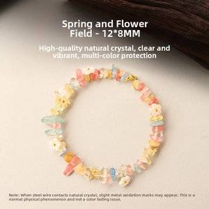 Detail of colorful natural crushed crystal bracelet with small white flower charms
