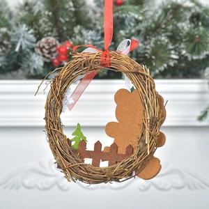 Christmas rattan wreath with wooden fence and gingerbread felt characters for festive decor