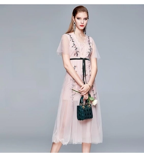 Détail de la broderie florale sur la robe en tulle rose avec dentelle fine
