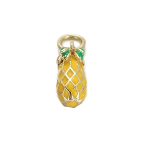 Macro view of a yellow pineapple charm with green leaves for DIY necklaces or bracelets