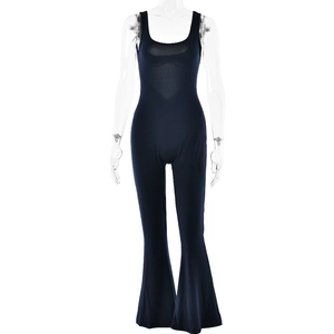 Detail view of navy blue backless jumpsuit with spaghetti straps and flared leg style