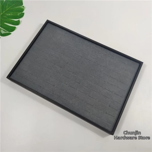Detail view of large capacity jewelry tray with gray velvet slots for ring display