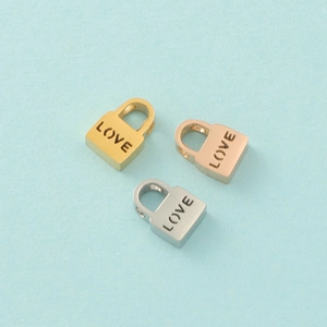Detailed macro view of heart-shaped Love lock beads in gold, silver, and rose gold