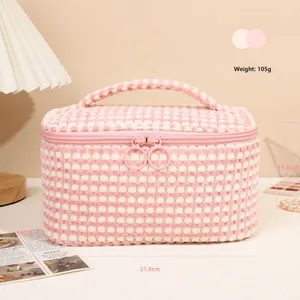 Pink and white checkered plush makeup bag with double zippers and soft handle