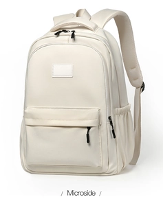 Detail of minimalist beige nylon backpack showing padded S-shaped ergonomic straps