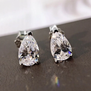 Macro shot of silver pear-cut cubic zirconia stud earrings with claw setting
