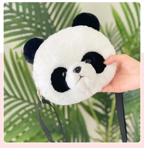 Detailed view of a soft plush panda head coin purse with a black shoulder strap and metal clip