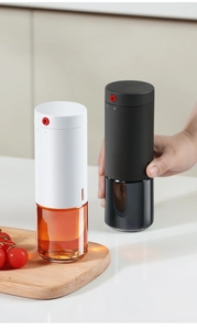 Detail of oil spray bottle with rotary lock and matte lid on kitchen counter
