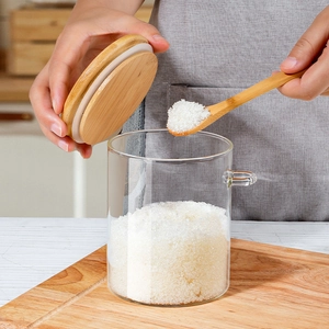 Borosilicate glass storage jar with wooden lid and spoon for kitchen organization