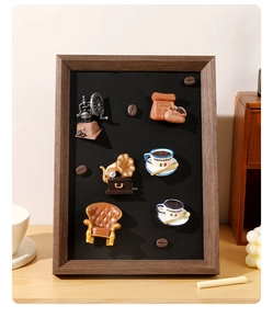 Macro view of vintage 3D resin coffee-themed fridge magnets set in a dark display frame