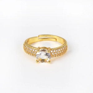 Detail of gold-plated adjustable ring with a central zircon and pavé-set side stones