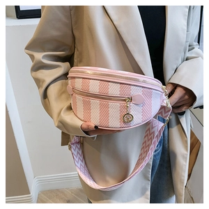 Detailed view of pink and white striped crescent bag with gold zipper and wide strap