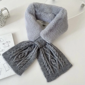 Detail showing plush faux fur and grey cable-knit texture of the winter scarf