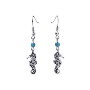 Detailed close-up of silver seahorse earrings featuring small sky blue beads for accents